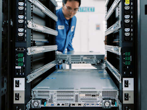Penguin employee assembles a server rack