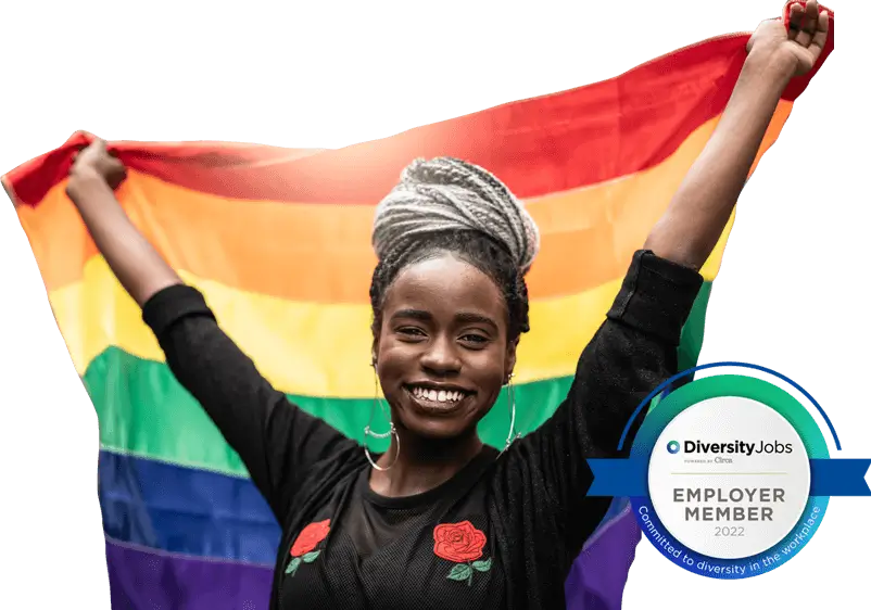 Smiling woman holding rainbow flag. SGH is a member of Diversity Jobs and committed to diversity in the workplace.